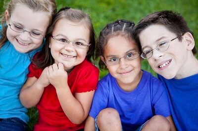 Group of Four Children Wearing Glasses