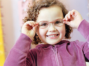 Child smiling with glasses