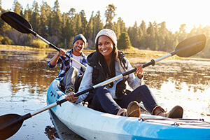 Man and Woman Paddling a Boat on a Lake after LASIK