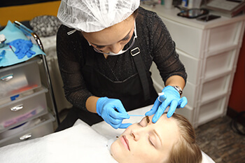 Woman receiving the microblading procedure